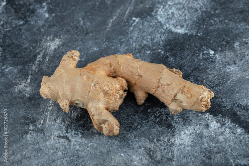 Single fresh ginger on marble background