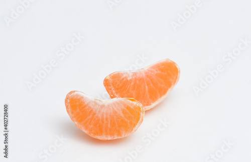 Two slices of tangerine on white isolated background