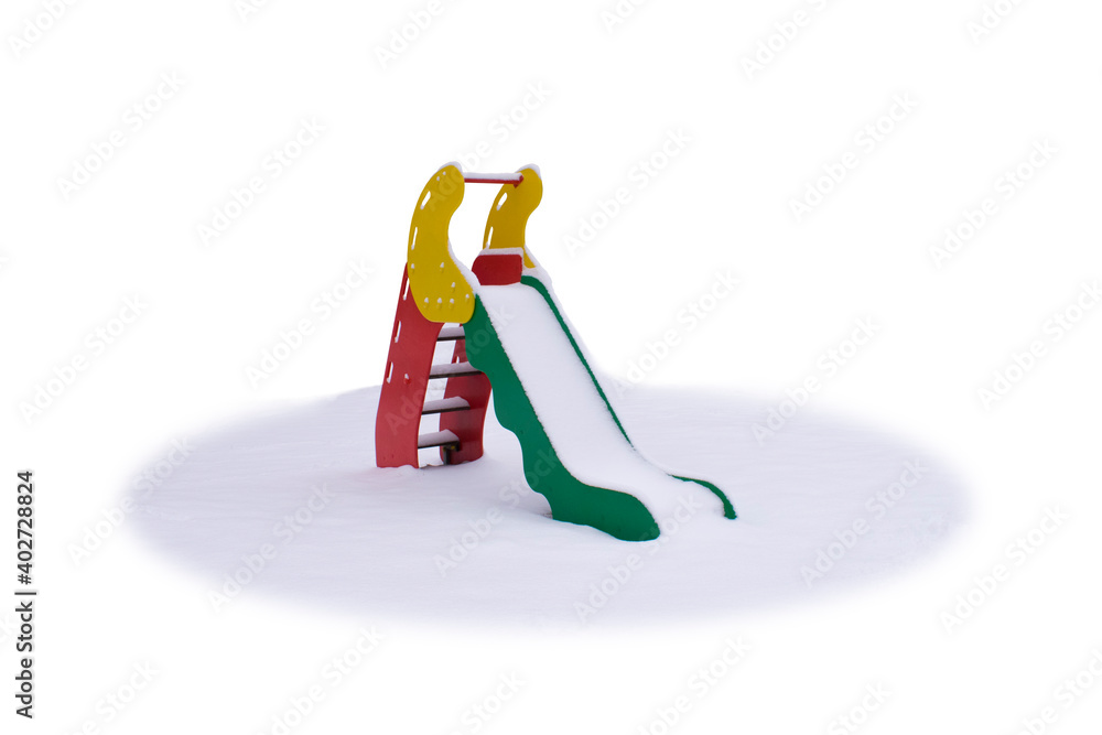 Obraz premium Snow covered colorful children's slide isolated on white background.