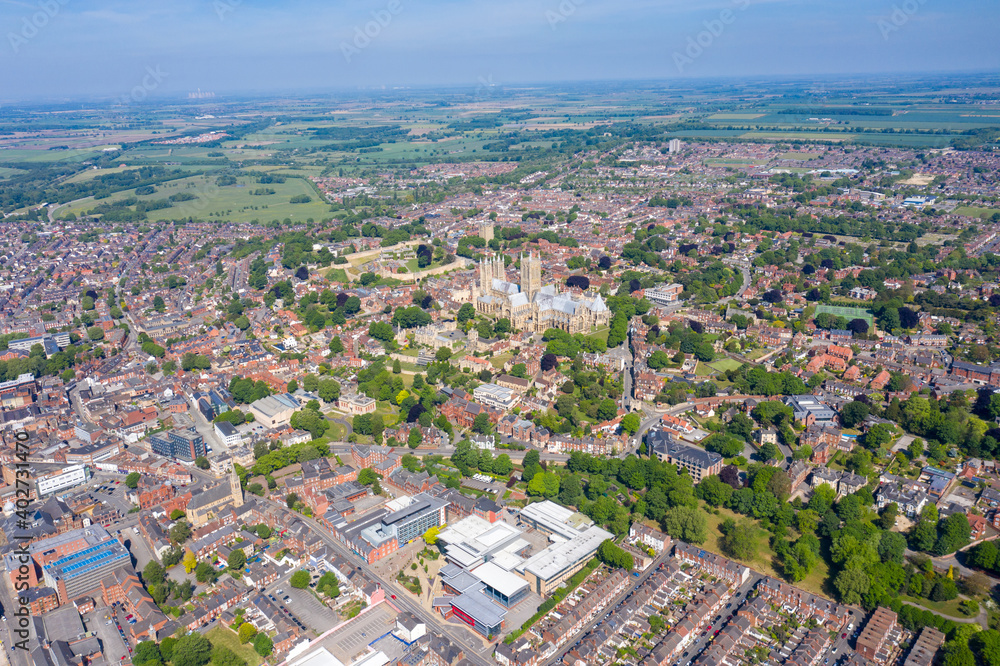 Aerial footage of the Lincoln Cathedral, Lincoln Minster in the UK city centre of Lincoln East Midlands on a bright sunny summers day showing the historic Cathedral Church in the British city centre