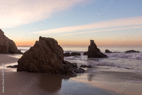 Fototapeta Naklejka Na Ścianę i Meble -  Colorful sunrise on the rocky beach of Malibu, California