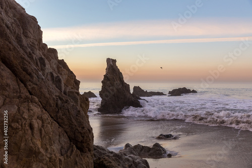Sunrise at rocky shore of Pacific Ocean at Malibu, California