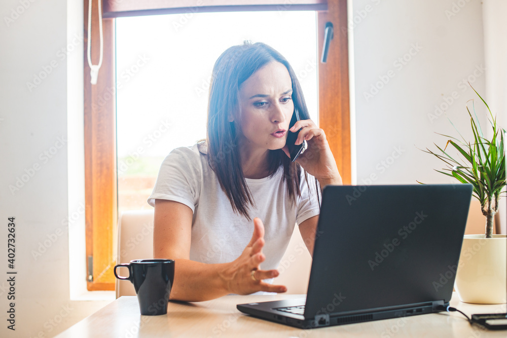 Angry woman calling to customer service with a laptop failure Angry woman calling to customer service with a laptop failure