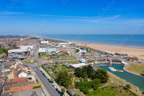 Aerial photo of the town centre of Skegness showing the pier on the sandy beach near fairground rides in the East Lindsey district of Lincolnshire, England © Duncan