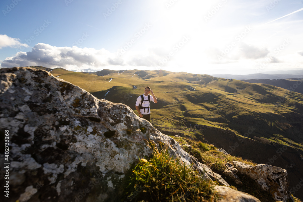 Mountain hiker on the top of the Txindoki peak at the Basque Country.