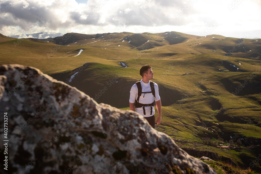 Mountain hiker on the top of the Txindoki peak at the Basque Country.
