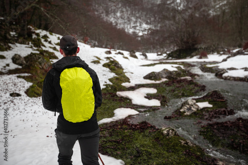 Hiker walking through a winter landscape