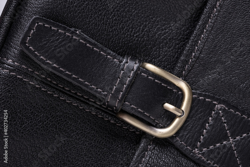 Blacl leather textured background with metal buckle