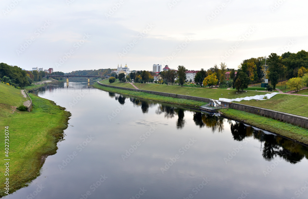 View of the Western Dvina (Zapadnaya Dvina) river in the center of the city of Vitebsk in the Republic of Belarus. Autumn landscape in town