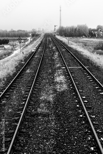 Two railroad tracks leading through the fields. Railway traction near the railway station.
