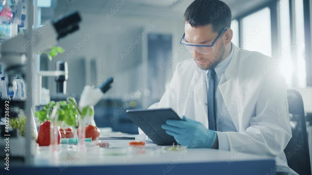 Male Microbiologist with Tablet Looking at a LabGrown Cultured Vegan