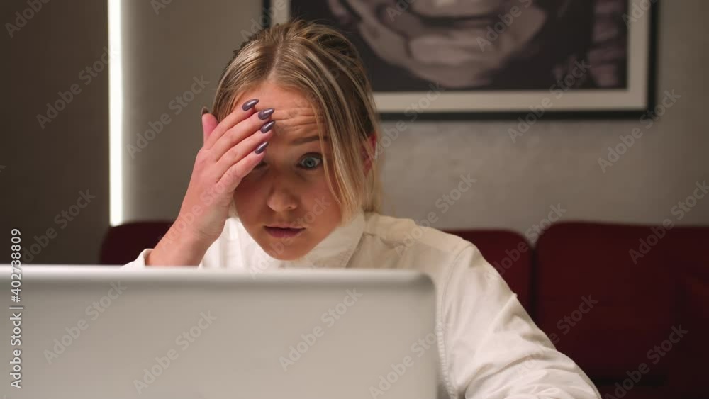 Close up tired sad businesswoman face looking at laptop at the home office. Close up of upset woman thinking about mistakes in work. Portrait of sad girl looking laptop. Depressed employee working on Close up tired sad businesswoman face looking at laptop at the home office. Close up of upset woman thinking about mistakes in work. Portrait of sad girl looking laptop. Depressed employee working on