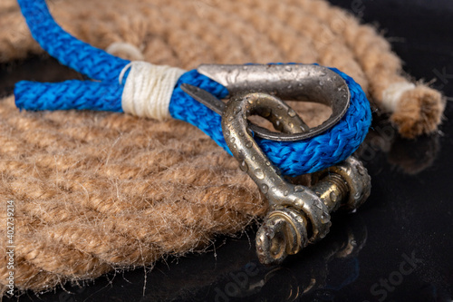 Wet shackle and rope. Accessories for sea wolves on the table. photo