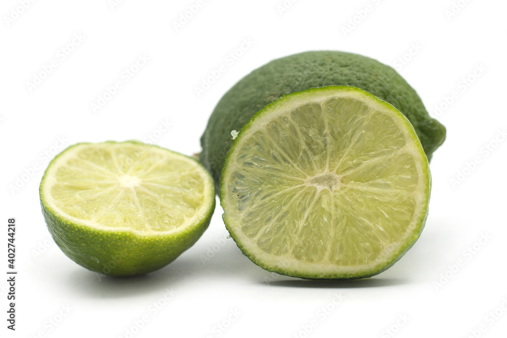 Closeup of fresh green lemon on white background Closeup of fresh green lemon on white background