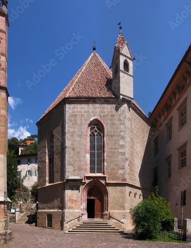 Octagonal gothic chapel of St Barbara with entrance door and pointed window arch in the old medieval town of Merano in South Tyrol, Italy