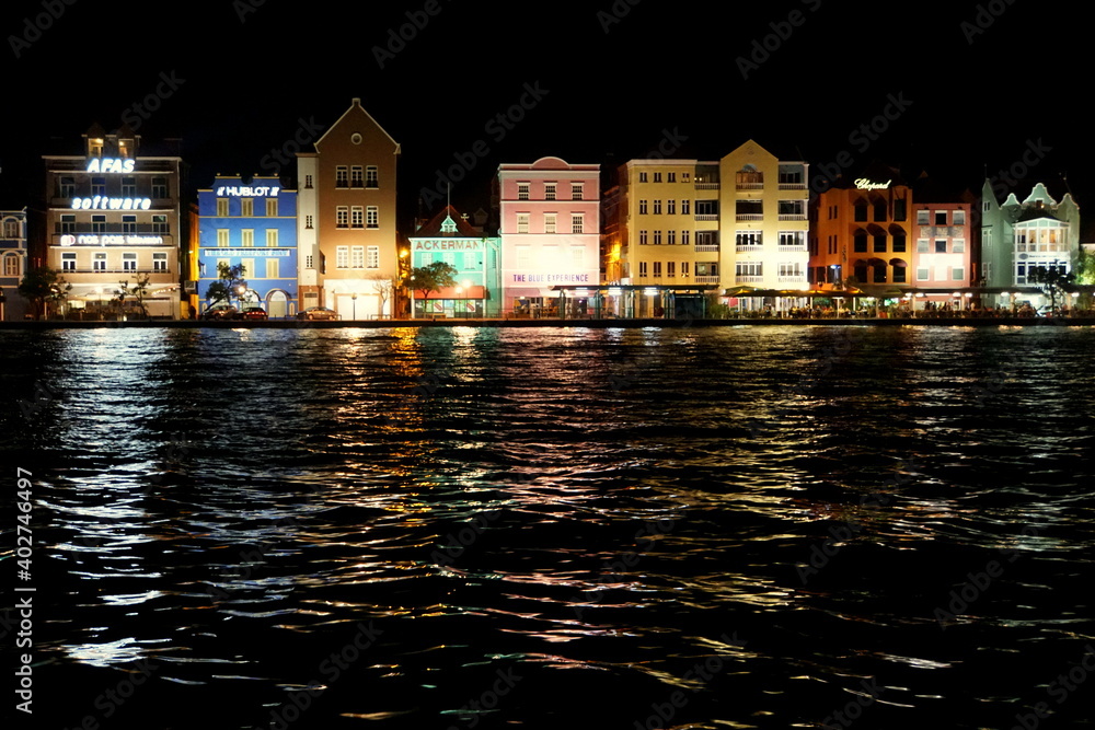 The view of the lighted up buildings along St Anna Bay at night near Willemstad, Curacao
