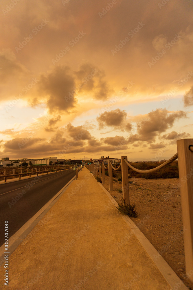 Beautiful and colorful sunset with cloud in the road