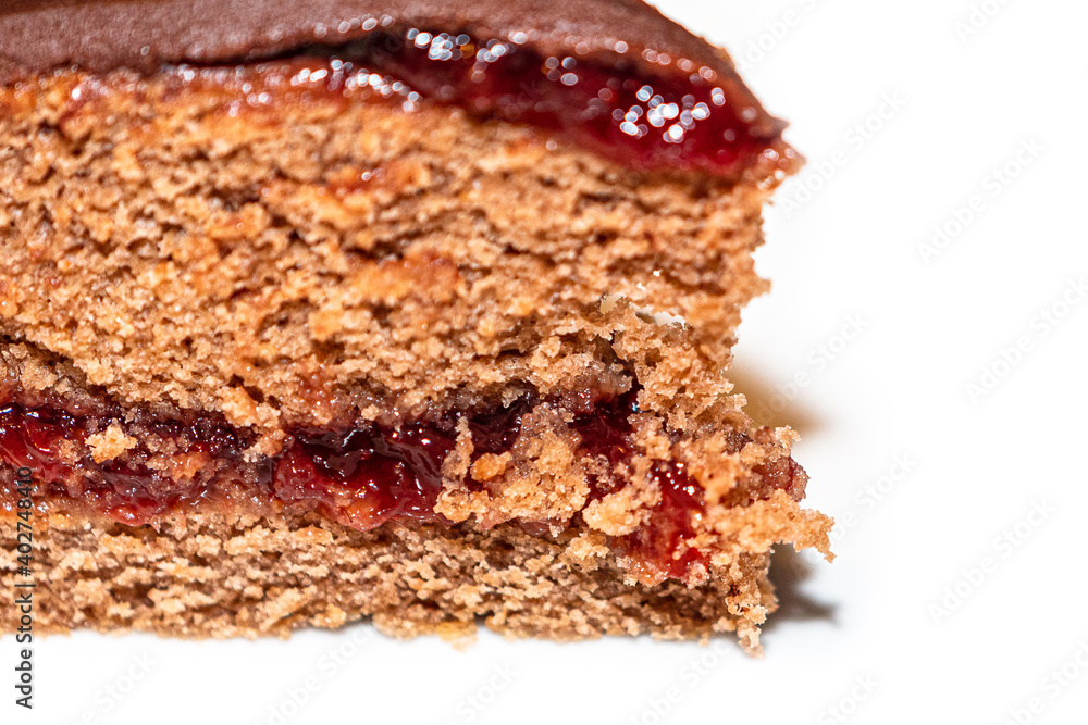 Detail of slice of chocolate cake with strawberry jam filling