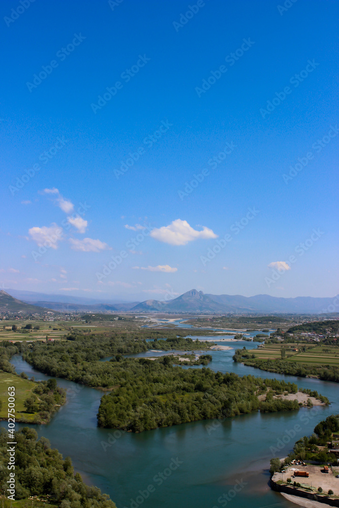 Beautiful cityscape from Skodra, Shkodër, Albania. Scenic view of river and Shkodra cityscape from Rozafa Castle with cloudy sky. 