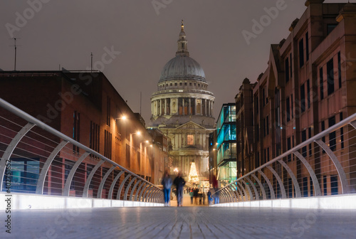 View from the Millennium Bridge of the Saint Paul's Cathedral in the city of London illuminated at dusk © cristianbalate
