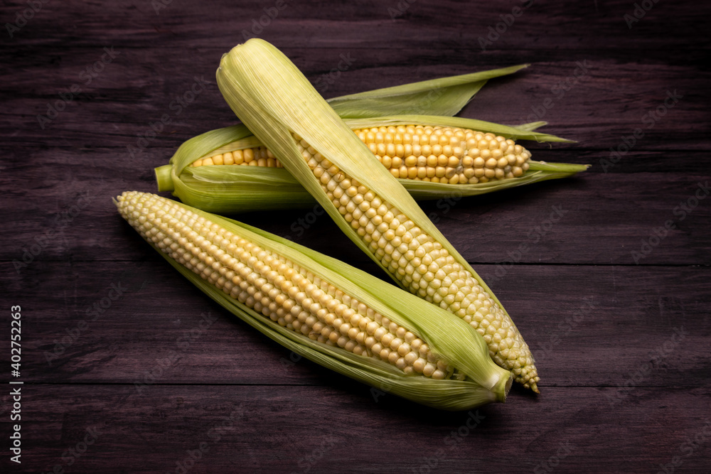 corn cobs on a dark wooden table corn cobs on a dark wooden table