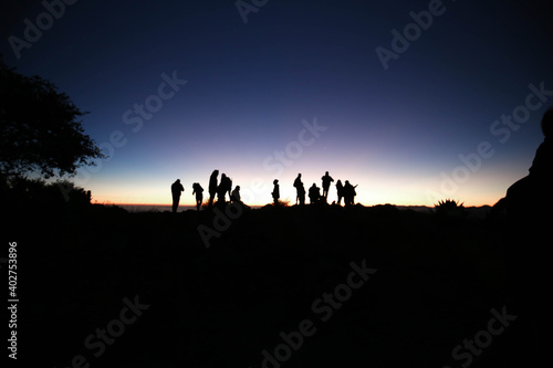 silhouette of people and Epic and colorful sunrise in the to mountains © Mylifeontopdm