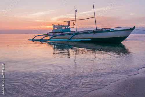 Sunset view of a bangka double-outrigger boat on Siquijor island, Philippines.