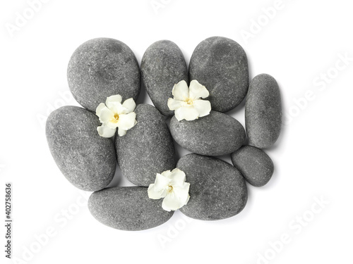 Spa stones and flowers on white background  top view