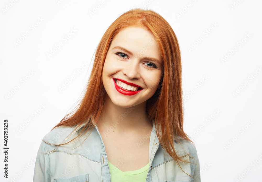 Lifestyle and people concept: Young cute smiling redhair woman over white background