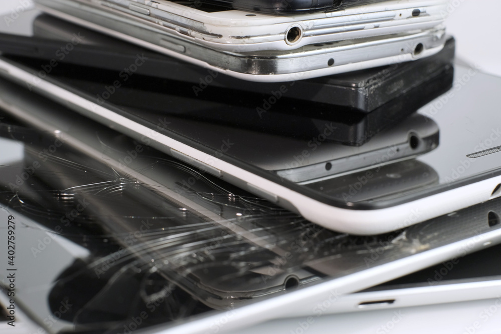 Broken Mobile Smart Phone and pad with crashed Screen Glass Lcd. gadgets lying one on top of another. Devices are prepared for utilization. Broken Mobile Smart Phone and pad with crashed Screen Glass Lcd. gadgets lying one on top of another. Devices are prepared for utilization.