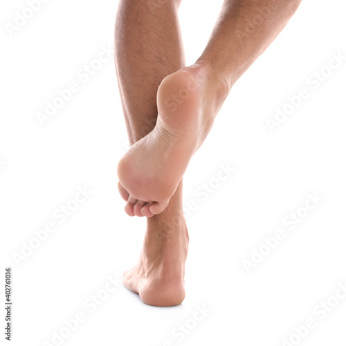 Back view of man standing against white background, closeup on feet © New Africa