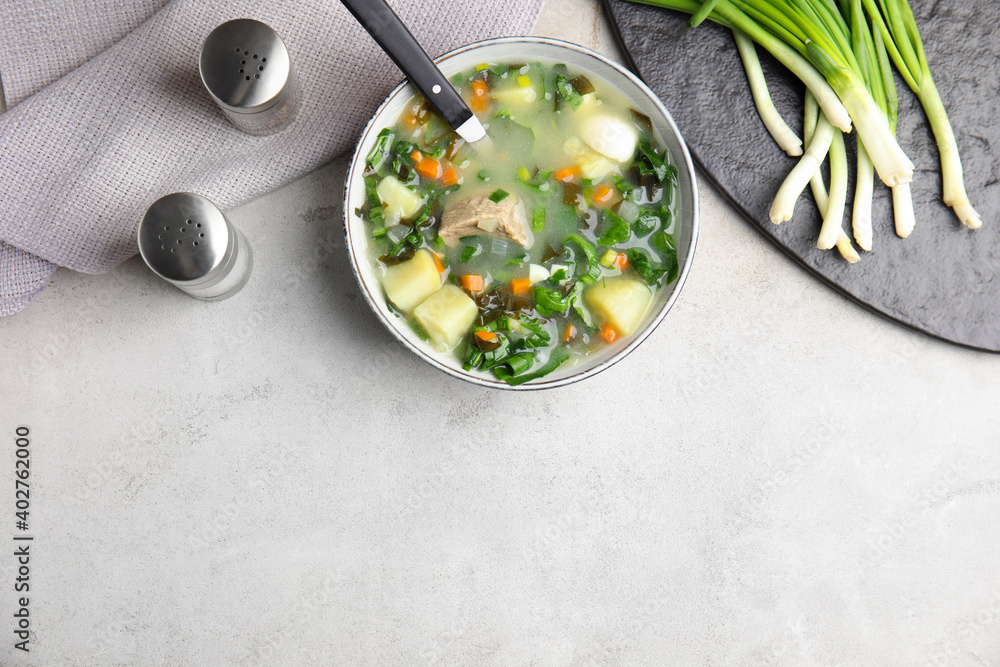 Delicious sorrel soup with meat served on table, flat lay. Space for text Delicious sorrel soup with meat served on table, flat lay. Space for text