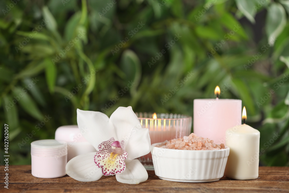 Beautiful spa composition with sea salt and candles on wooden table Beautiful spa composition with sea salt and candles on wooden table