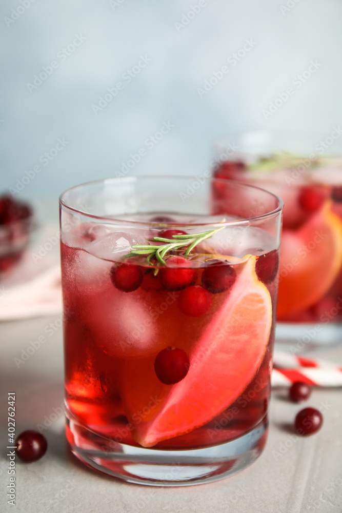 Tasty refreshing cranberry cocktail on light grey table Tasty refreshing cranberry cocktail on light grey table