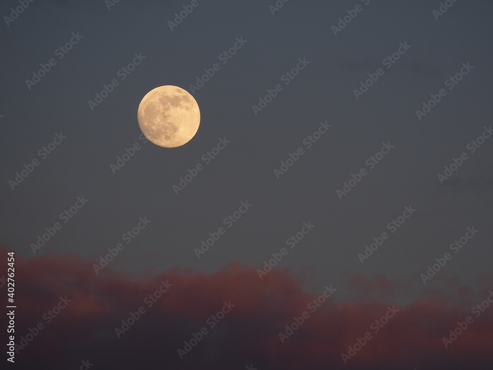 the last full moon of 2020 over clouds the last full moon of 2020 over clouds