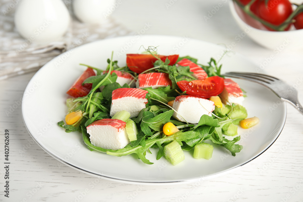 Tasty crab stick salad served on white table, closeup Tasty crab stick salad served on white table, closeup