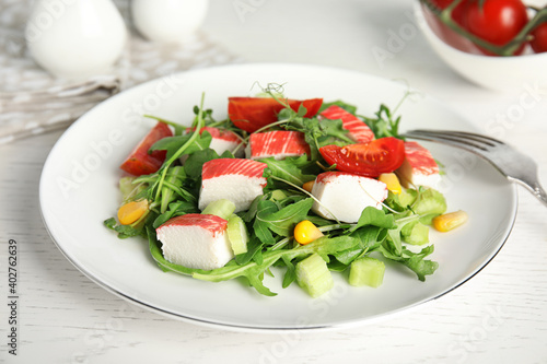 Tasty crab stick salad served on white table, closeup © New Africa