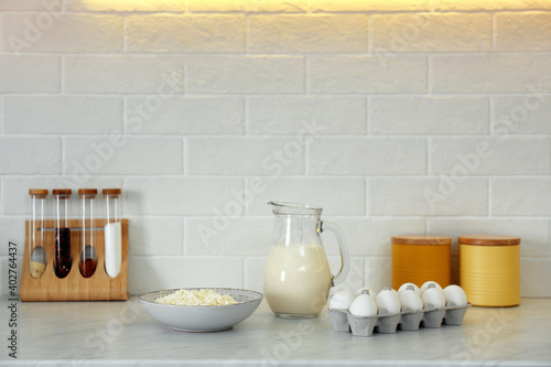 Different dairy products and eggs on countertop in modern kitchen