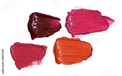 Four Shades of Lipstick and Lip Gloss Swatches on a White Background