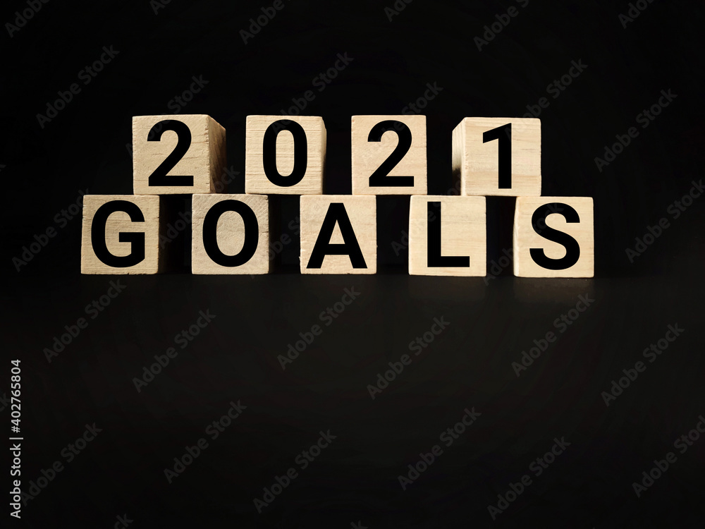 Obraz premium 2021 GOALS text on wooden blocks with black background. Business Concept. Stock photo.
