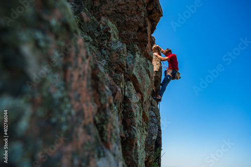 Sportive man exercising on wall for climbing