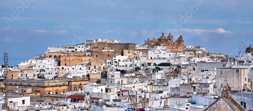 View of the old white town of Ostuni and the cathedral at sunrise. Brindisi, Apulia in southern Italy. Europe.