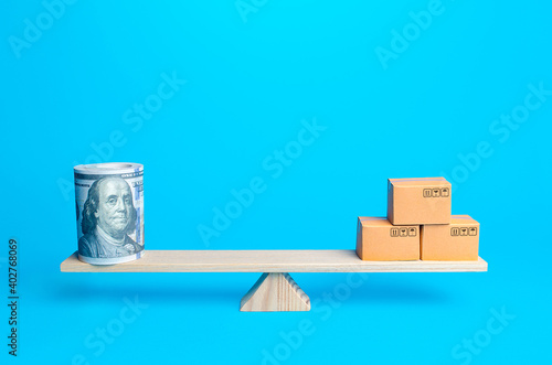 Bild auf Leinwand Money bundle of dollars and boxes on scales