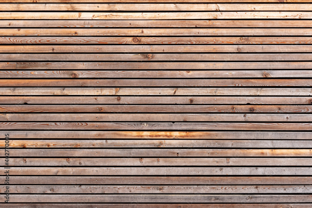 Texture pattern of a brown wood facade with planks. Aged timber structure closeup. Texture pattern of a brown wood facade with planks. Aged timber structure closeup.