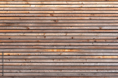 Texture pattern of a brown wood facade with planks. Aged timber structure closeup.