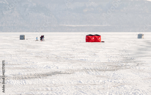 People are ice fishing on frozen Mississippi River