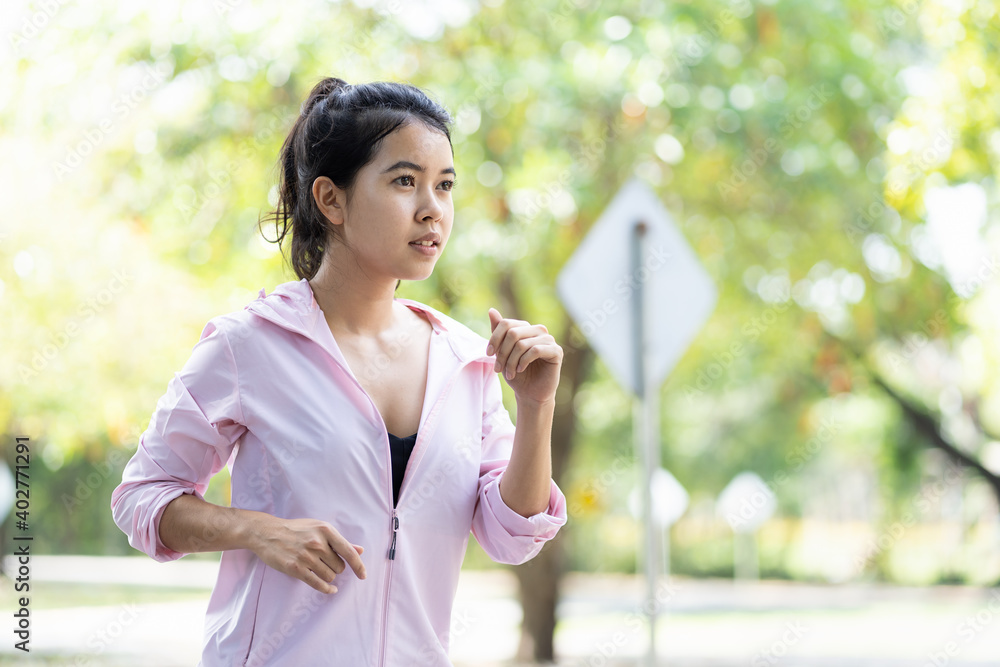 Attractive Asian young woman runner running outdoor in the park. Sport girl in sportswear running or jogging in summer day. Woman, Sport and exercise concept Attractive Asian young woman runner running outdoor in the park. Sport girl in sportswear running or jogging in summer day. Woman, Sport and exercise concept