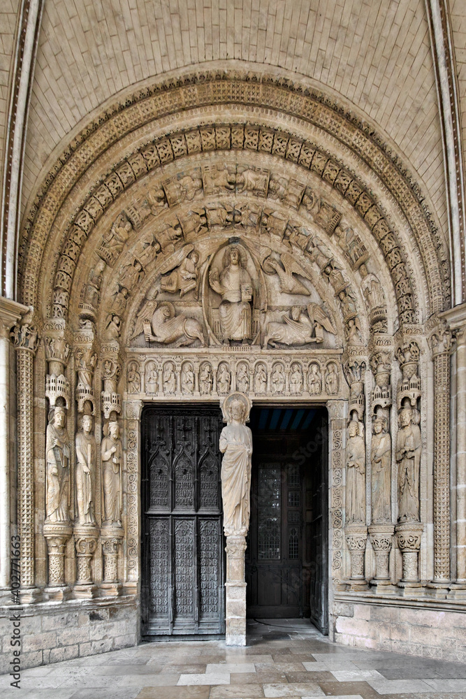 Saint-Étienne Cathedral, Bourges, France. The south portal is from the 13th century. In the tympanum, Christ is surrounded by the symbols of the evangelists. In the pillar a Christ blessing.