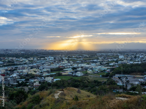 view of sun shinning over city in Sunset time