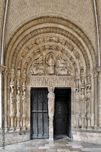 Saint-Étienne Cathedral, Bourges, France. The south portal is from the 13th century. In the tympanum, Christ is surrounded by the symbols of the evangelists. In the pillar a Christ blessing. © Paolo
